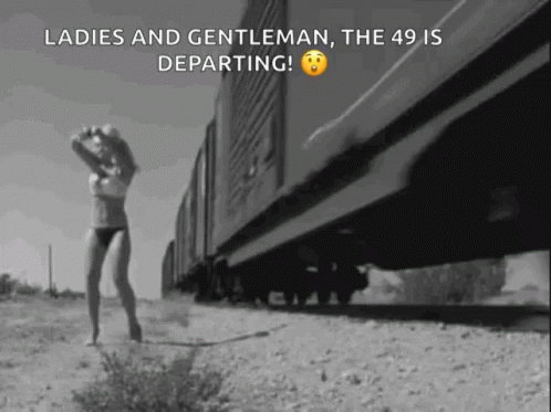 Black and White Woman in Lingerie Walking Beside Train