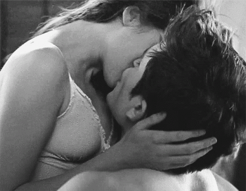 Black and White Woman Kissing Man on Neck