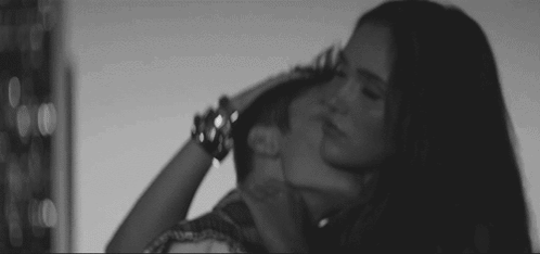 Black and White Woman Kissing Man's Neck