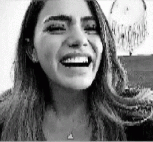 Black and White Woman Laughing by Dream Catcher