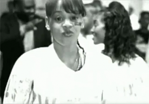 Black And White Woman Standing In Crowd GIF