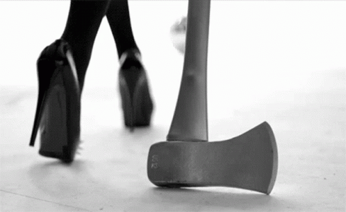 Black and White Woman Walking Next to Axe