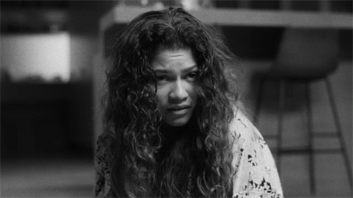 Black And White Woman With Curly Hair Making Sad Face GIF