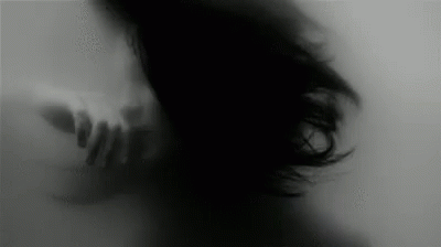 Black And White Woman With Hand Behind Her GIF