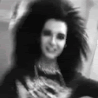 Black And White Woman With Long Hair Smiling At Camera GIF