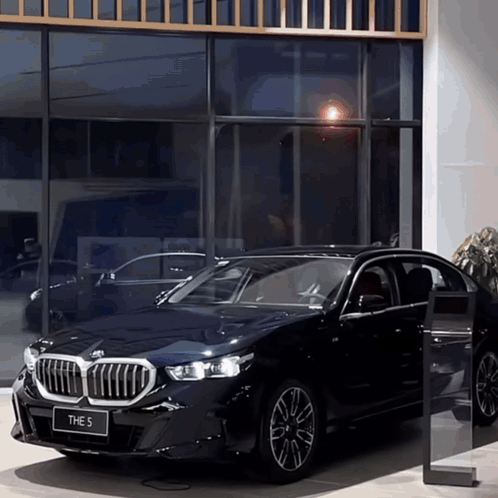 Black BMW 5 Parked in Front of Building