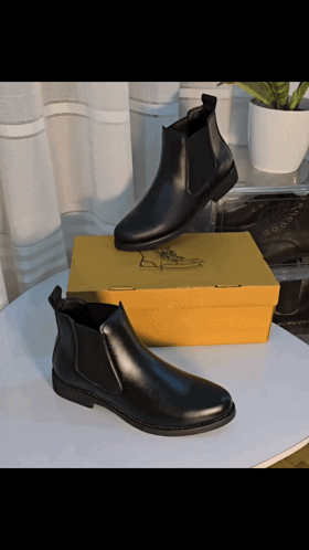 Black Boots Next to Yellow Box