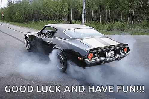 Black Car Driving Down Road Saying Good Luck and Have Fun