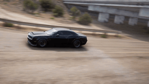 Black Car Driving Under Bridge