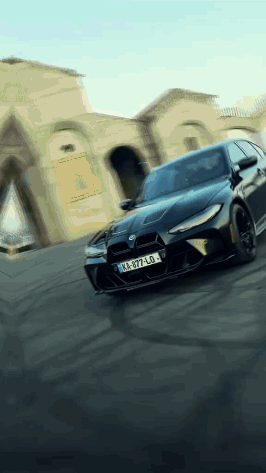 Black Car With License Plate KA-977-LO Driving Down Street