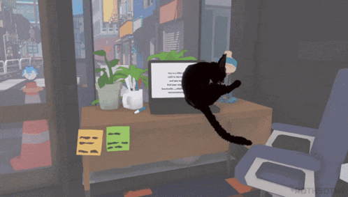 Black Cat Sitting at Computer Desk