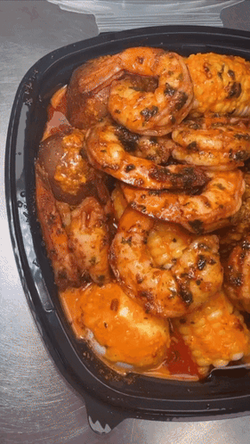 Black Container with Shrimp Chicken and Potatoes