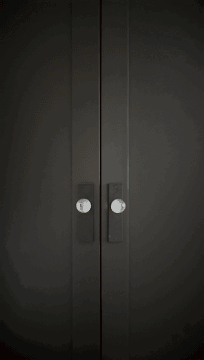 Black Door With White Sign Saying Mo GIF