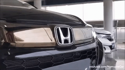 Black Honda Parked Next to White Car