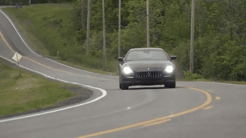 Black Maserati Driving Down Curvy Country Road