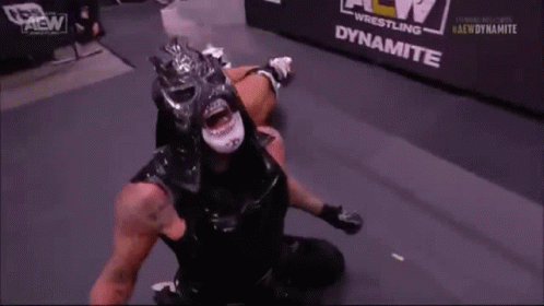 Black Masked Wrestler Open Mouth in Ring