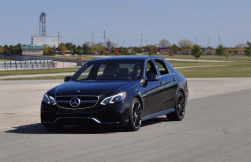 Black Mercedes Driving Past Emerson Building