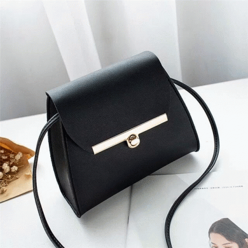 Black Purse Next to Magazine