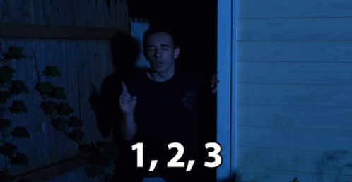 Black Shirt Man at Doorway with Numbers 1 2 3