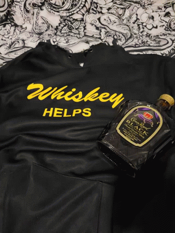 Black Shirt Says Whiskey Helps Next to Bottle