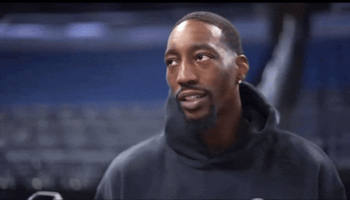 Black Sweatshirt Man Talking Into Mic Holding Phone