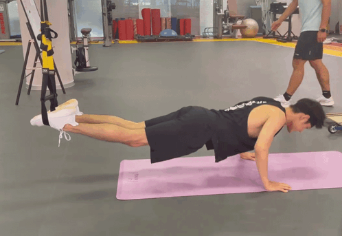 Black Tank Top Man Doing Push Ups on Purple Mat