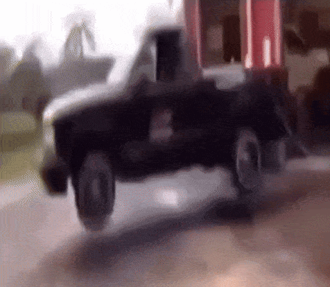 Black Toy Truck Driving Down Road GIF