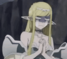 Blonde Anime Girl Sitting With Hands Folded In Prayer GIF