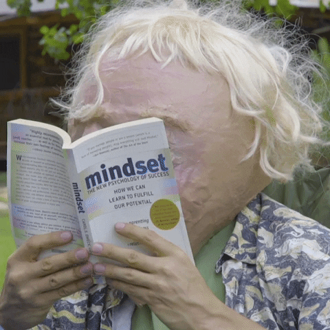 Blonde Creature Laughing Reading Book GIF