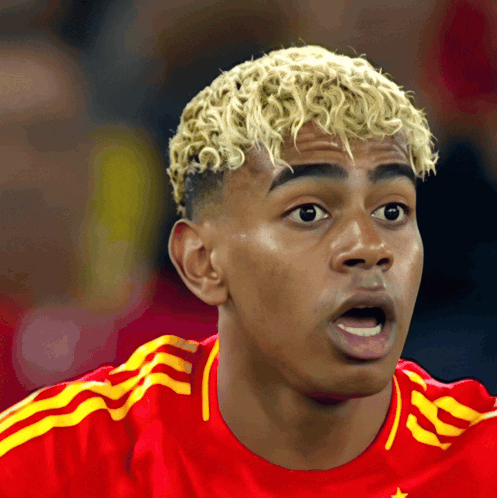 Blonde Curly Hair Man in Red and Yellow Adidas Jersey