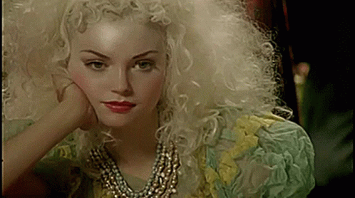 Blonde Curly Hair Woman in Pearl Necklace and Green Yellow Dress