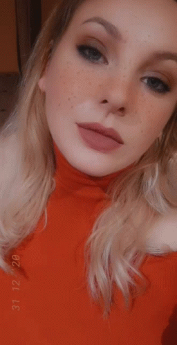 Blonde Girl In Red Dress Rolls Eyes GIF