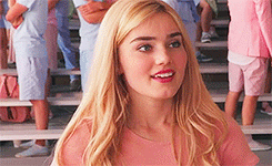 Blonde in Pink Shirt on Bench Facing Crowd