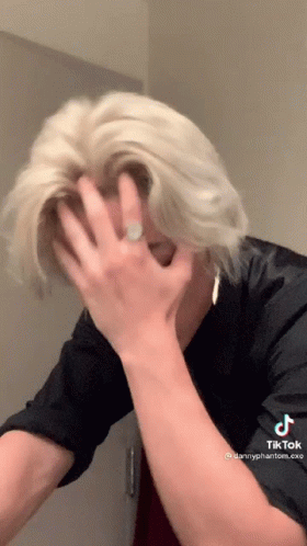 Blonde Man Covering Face With Ring On Hand GIF