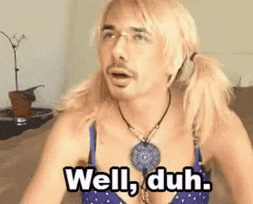 Blonde Man in Bra Necklace Saying Well Duh