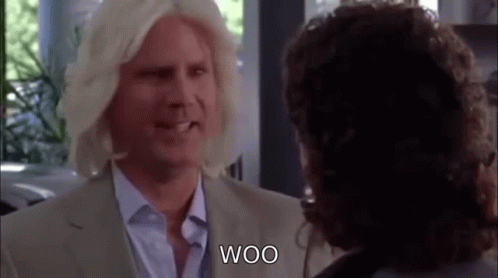 Blonde Man in Wig Talking to Another Man