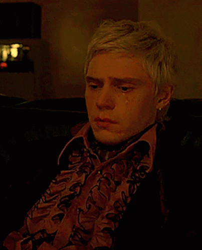 Blonde Man Sitting on Couch Crying