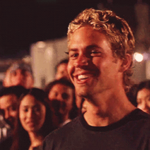 Blonde Man Smiling in Crowd