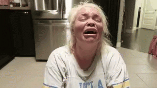 Blonde Woman Crying in Kitchen UCLA Shirt