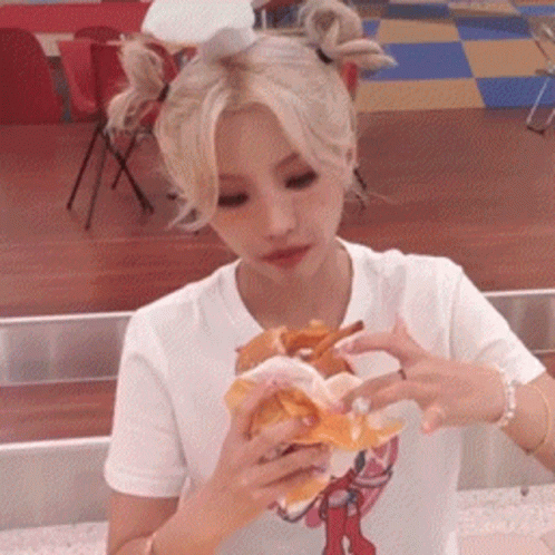Blonde Woman Eating Hamburger