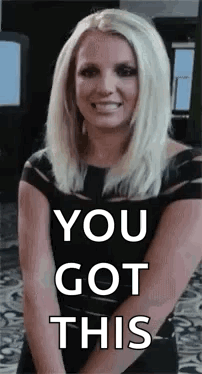 Blonde Woman in Black Dress Smiling Hands Together