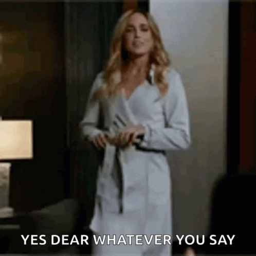Blonde Woman In Black Mask And Suit GIF
