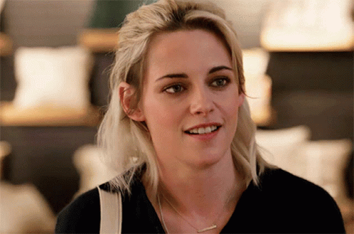 Blonde Woman in Black Shirt and Necklace Smiling