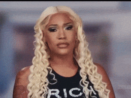 Blonde Woman in Black Tank Top Saying Rich