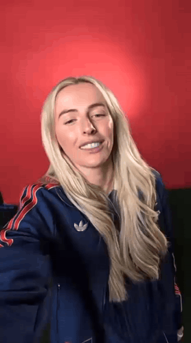 Blonde Woman in Blue Adidas Jacket Making Funny Face