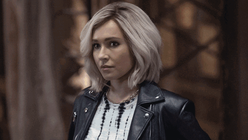 Blonde Woman In Leather Jacket And Necklace GIF