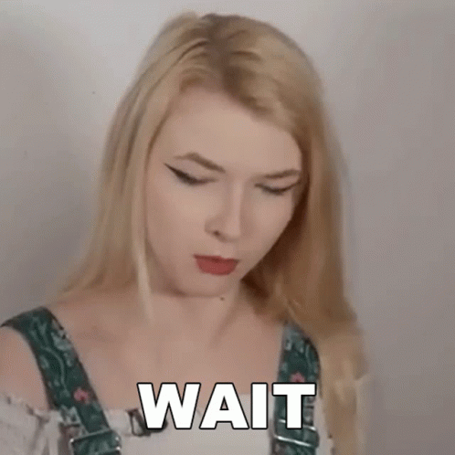 Blonde Woman in Overalls Making Funny Face Saying Wait