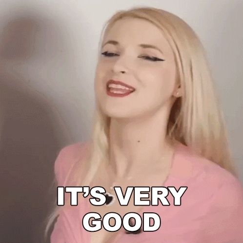 Blonde Woman In Pink Shirt Smiling Saying Very Good GIF
