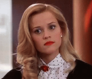 Blonde Woman In Polka Dot Shirt And Black Jacket GIF