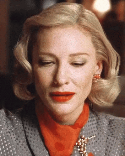 Blonde Woman in Polka Dot Suit and Red Scarf